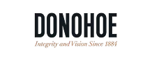 The image shows the word "Donohoe" in large black letters, with the phrase "Integrity and Vision Since 1884" in smaller gold script below.