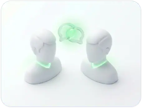 Two stylized, faceless white human busts face each other with green glowing necks and two overlapping green chat bubbles between them, symbolizing digital communication or conversation.